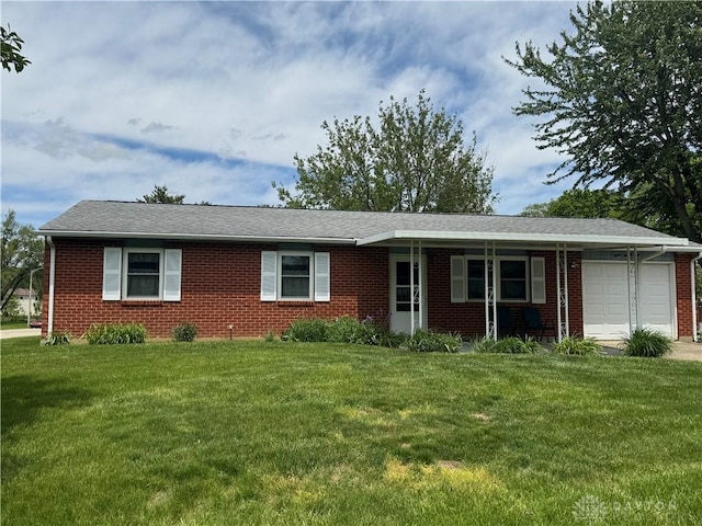326 Little League Dr, Eaton, OH 45320 - single story home with a garage, brick siding, and a front lawn