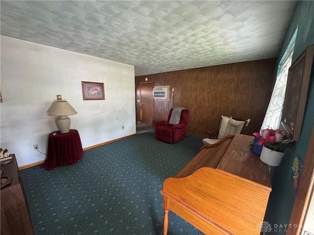326 Little League Dr, Eaton, OH 45320 - sitting room featuring a textured ceiling, baseboards, carpet, wooden walls, and healthy amount of natural light