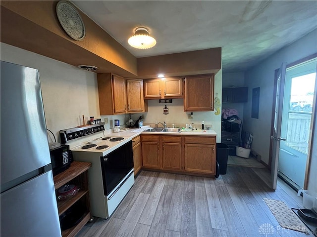 326 Little League Dr, Eaton, OH 45320 - kitchen featuring freestanding refrigerator, electric range, a sink, light countertops, and light wood-type flooring