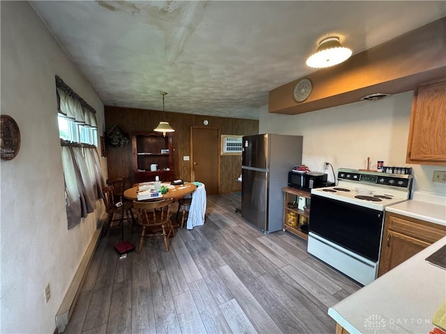 326 Little League Dr, Eaton, OH 45320 - kitchen with electric range, freestanding refrigerator, black microwave, wood finished floors, and light countertops