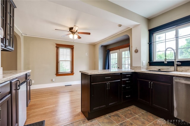 1809 Shroyer Rd, Oakwood, OH 45419 - kitchen with stainless steel dishwasher, a ceiling fan, light stone countertops, arched walkways, and a peninsula