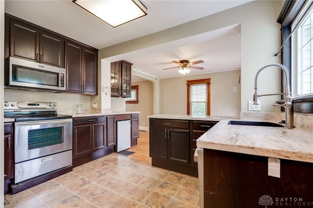 1809 Shroyer Rd, Oakwood, OH 45419 - kitchen with appliances with stainless steel finishes, dark brown cabinets, and light stone counters