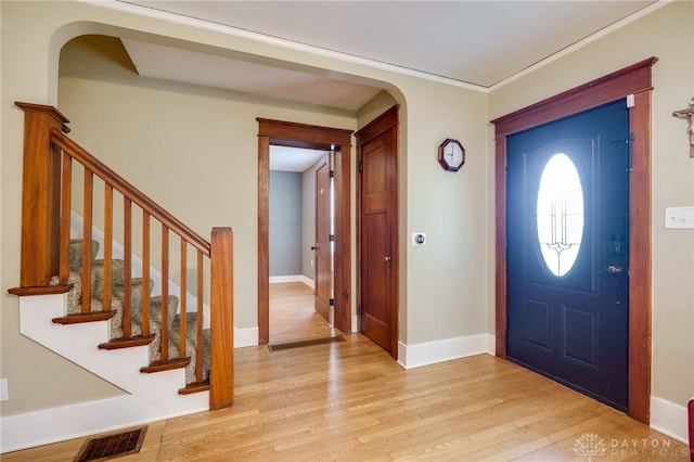 1809 Shroyer Rd, Oakwood, OH 45419 - entrance foyer featuring arched walkways, light wood-style floors, stairs, and crown molding