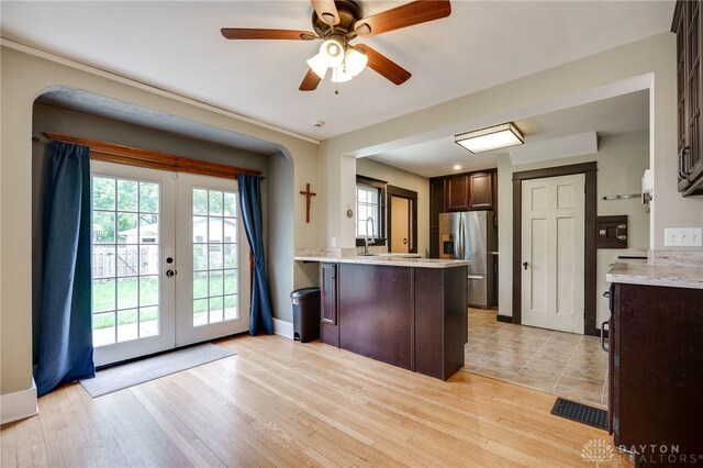 1809 Shroyer Rd, Oakwood, OH 45419 - kitchen with stainless steel fridge, french doors, dark brown cabinetry, a peninsula, and plenty of natural light
