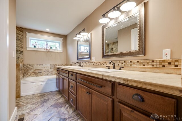 1809 Shroyer Rd, Oakwood, OH 45419 - bathroom with double vanity, a garden tub, and tasteful backsplash