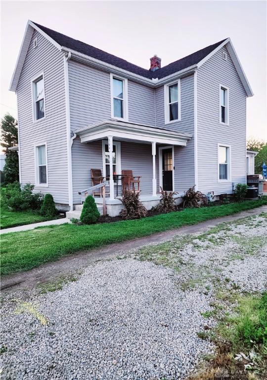 304 W Walnut St, Botkins, OH 45306 - view of front facade with a chimney and a porch