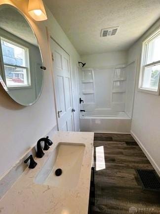 304 W Walnut St, Botkins, OH 45306 - bathroom with baseboards, bathing tub / shower combination, wood finished floors, and vanity