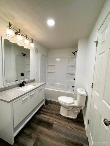 304 W Walnut St, Botkins, OH 45306 - bathroom featuring toilet, vanity, wood finished floors, tub / shower combination, and recessed lighting