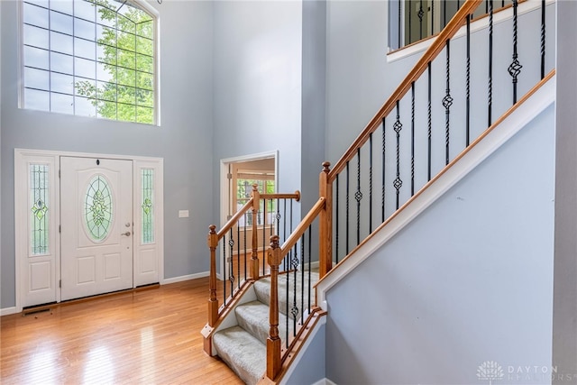6265 Amberley Ct, Liberty Twp, OH 45044 - entrance foyer featuring a high ceiling, wood finished floors, stairway, and baseboards