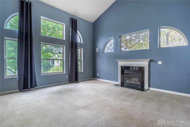 6265 Amberley Ct, Liberty Twp, OH 45044 - unfurnished living room with high vaulted ceiling, carpet, baseboards, and a fireplace with flush hearth