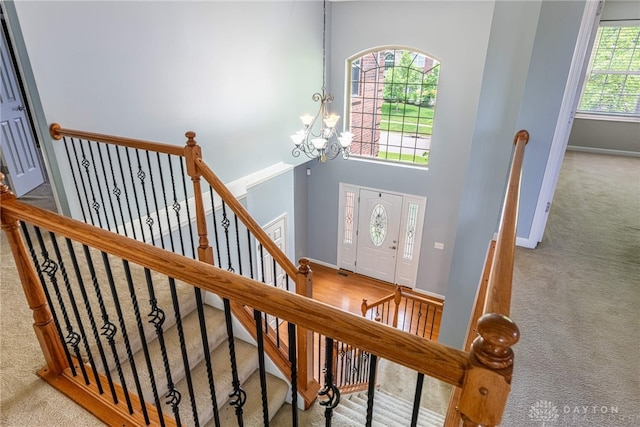 6265 Amberley Ct, Liberty Twp, OH 45044 - carpeted entrance foyer with a chandelier, baseboards, and a high ceiling