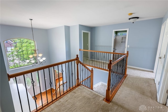 6265 Amberley Ct, Liberty Twp, OH 45044 - staircase featuring a chandelier, carpet, and baseboards