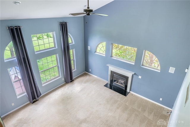 6265 Amberley Ct, Liberty Twp, OH 45044 - unfurnished living room featuring carpet flooring, baseboards, a ceiling fan, a fireplace with flush hearth, and a towering ceiling
