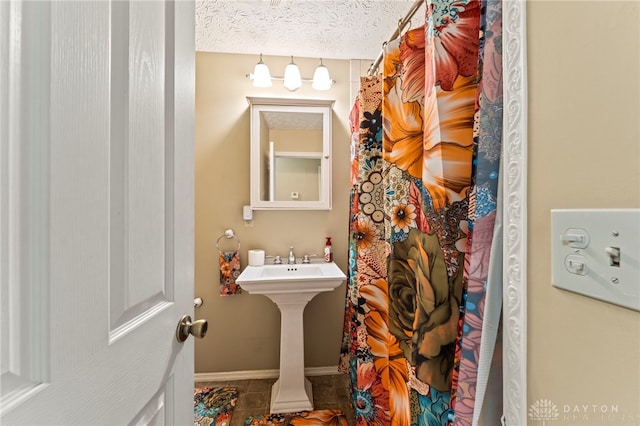 668 Dakota Dr, Xenia, OH 45385 - bathroom featuring tile patterned floors, a sink, baseboards, and a shower with shower curtain