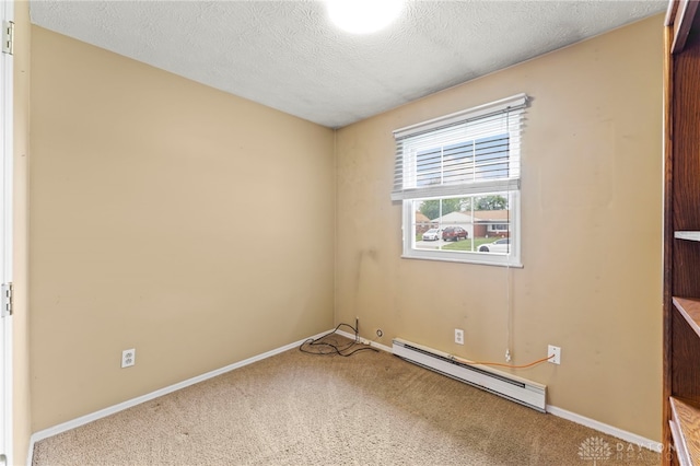668 Dakota Dr, Xenia, OH 45385 - unfurnished bedroom featuring a baseboard heating unit, carpet, baseboards, and a textured ceiling