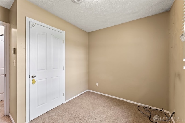 668 Dakota Dr, Xenia, OH 45385 - unfurnished bedroom with light colored carpet, baseboards, and a textured ceiling