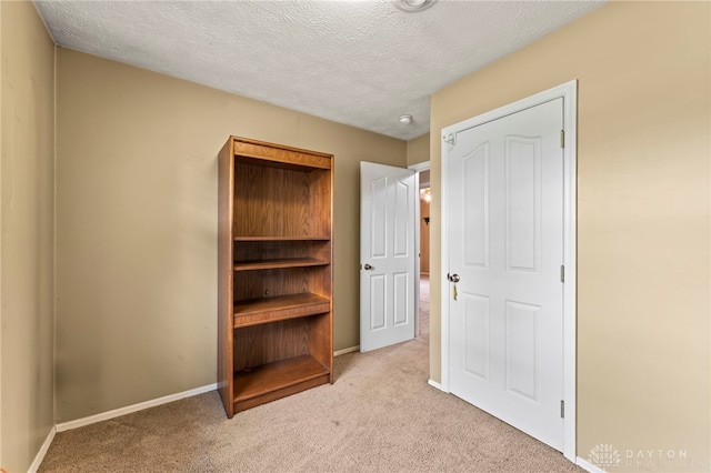 668 Dakota Dr, Xenia, OH 45385 - unfurnished bedroom with carpet flooring, a textured ceiling, and baseboards