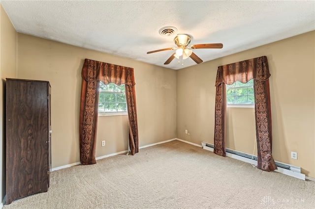 668 Dakota Dr, Xenia, OH 45385 - carpeted spare room with ceiling fan, baseboard heating, baseboards, and a textured ceiling