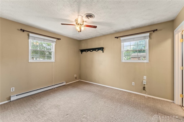 668 Dakota Dr, Xenia, OH 45385 - empty room with baseboard heating, carpet flooring, a ceiling fan, a textured ceiling, and baseboards