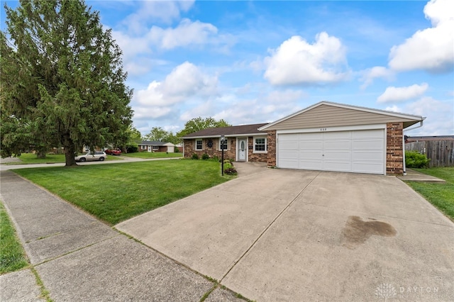 668 Dakota Dr, Xenia, OH 45385 - ranch-style house featuring concrete driveway, an attached garage, and brick siding