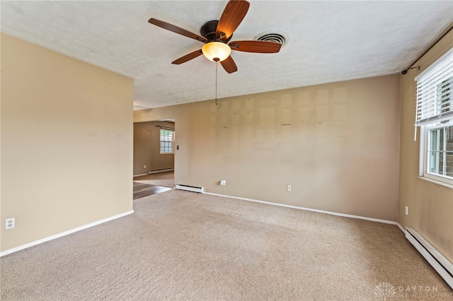 668 Dakota Dr, Xenia, OH 45385 - carpeted empty room with a baseboard radiator, ceiling fan, baseboards, baseboard heating, and a textured ceiling