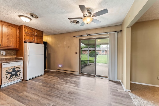 668 Dakota Dr, Xenia, OH 45385 - kitchen with white appliances, a baseboard heating unit, ceiling fan, a textured ceiling, and light wood-type flooring