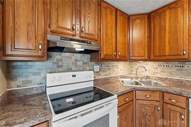668 Dakota Dr, Xenia, OH 45385 - kitchen with white electric stove, under cabinet range hood, a sink, brown cabinetry, and backsplash