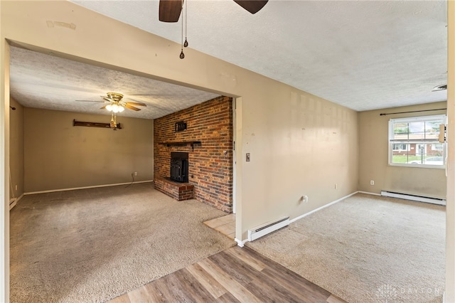 668 Dakota Dr, Xenia, OH 45385 - unfurnished living room with ceiling fan, baseboard heating, a textured ceiling, and wood finished floors