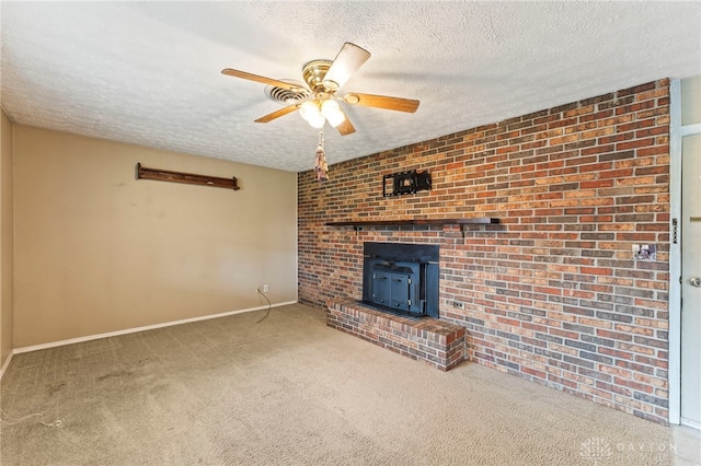 668 Dakota Dr, Xenia, OH 45385 - unfurnished living room with a wood stove, ceiling fan, a textured ceiling, carpet, and baseboards