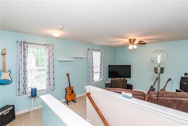 2385 Gerard Ct, Fairborn, OH 45324 - living room with light carpet, ceiling fan, a textured ceiling, and baseboards