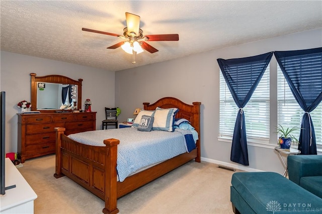 2385 Gerard Ct, Fairborn, OH 45324 - bedroom featuring light carpet, ceiling fan, baseboards, and a textured ceiling