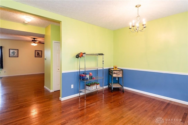 2385 Gerard Ct, Fairborn, OH 45324 - spare room featuring wood finished floors, a ceiling fan, a chandelier, baseboards, and a textured ceiling