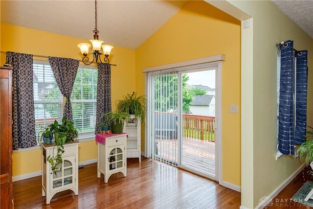 2385 Gerard Ct, Fairborn, OH 45324 - entryway featuring a chandelier, healthy amount of natural light, vaulted ceiling, wood-type flooring, and baseboards