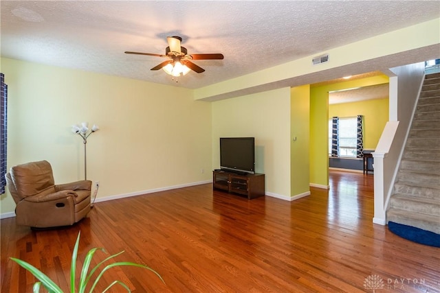 2385 Gerard Ct, Fairborn, OH 45324 - unfurnished living room featuring stairway, wood finished floors, ceiling fan, a textured ceiling, and baseboards