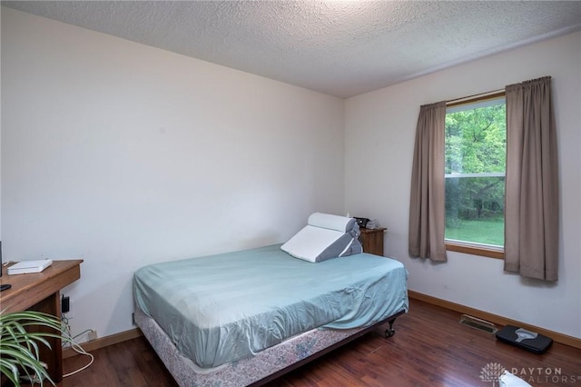 1646 Bell Hollow Rd, Hillsboro, OH 45133 - bedroom with wood finished floors, baseboards, and a textured ceiling