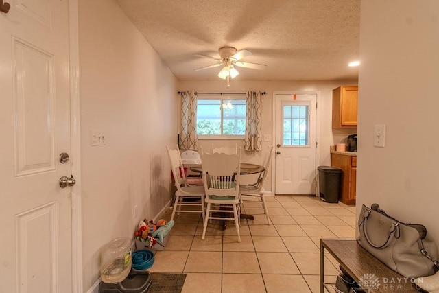 5864 Beecham Dr, Huber Heights, OH 45324 - dining space with ceiling fan, light tile patterned floors, a textured ceiling, and baseboards