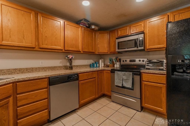 5864 Beecham Dr, Huber Heights, OH 45324 - kitchen with stainless steel appliances, light tile patterned floors, light countertops, recessed lighting, and brown cabinets