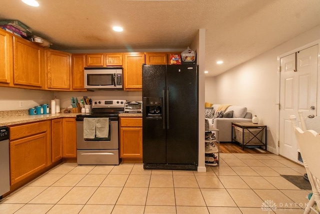 5864 Beecham Dr, Huber Heights, OH 45324 - kitchen with stainless steel appliances, light countertops, recessed lighting, light tile patterned floors, and brown cabinetry