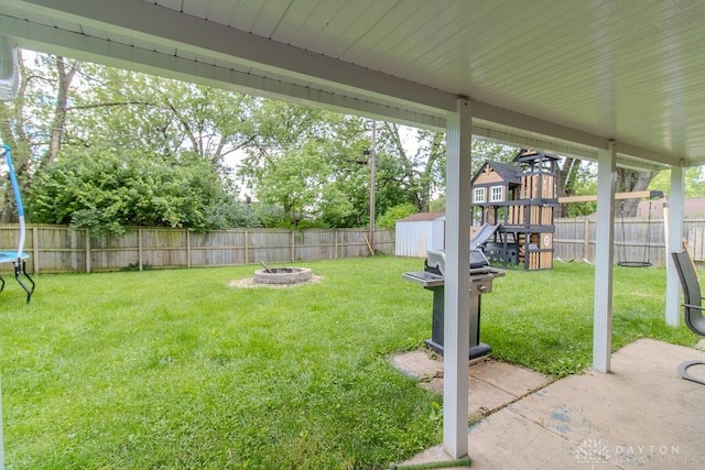 5864 Beecham Dr, Huber Heights, OH 45324 - view of yard featuring an outdoor fire pit, a playground, a trampoline, and a patio