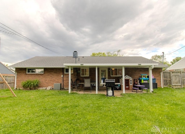 5864 Beecham Dr, Huber Heights, OH 45324 - back of property with brick siding, a patio area, and cooling unit