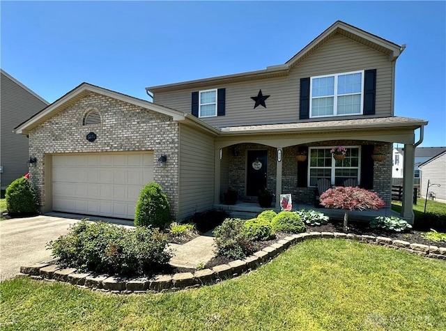 426 Sudbury Dr, Trenton, OH 45067 - traditional-style home featuring brick siding, a garage, concrete driveway, covered porch, and a front yard