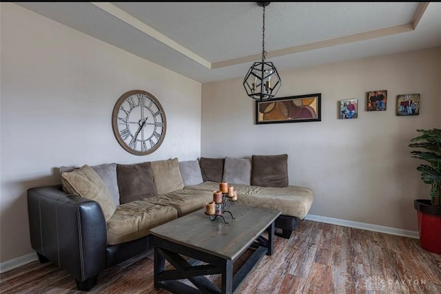 426 Sudbury Dr, Trenton, OH 45067 - living room featuring baseboards, a raised ceiling, and wood finished floors