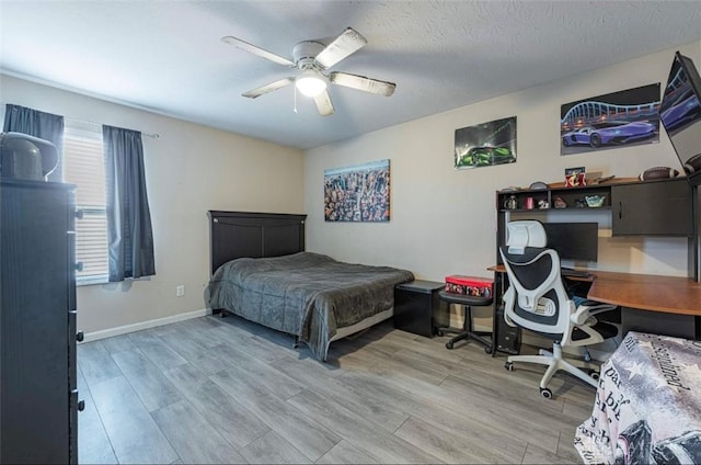 426 Sudbury Dr, Trenton, OH 45067 - bedroom with wood finished floors, a ceiling fan, baseboards, and an office area