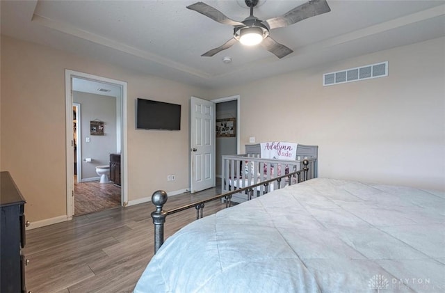 426 Sudbury Dr, Trenton, OH 45067 - bedroom featuring wood finished floors, baseboards, a raised ceiling, a ceiling fan, and connected bathroom