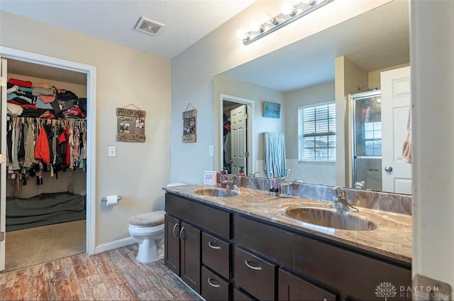 426 Sudbury Dr, Trenton, OH 45067 - full bathroom with wood finished floors, double vanity, a spacious closet, and toilet