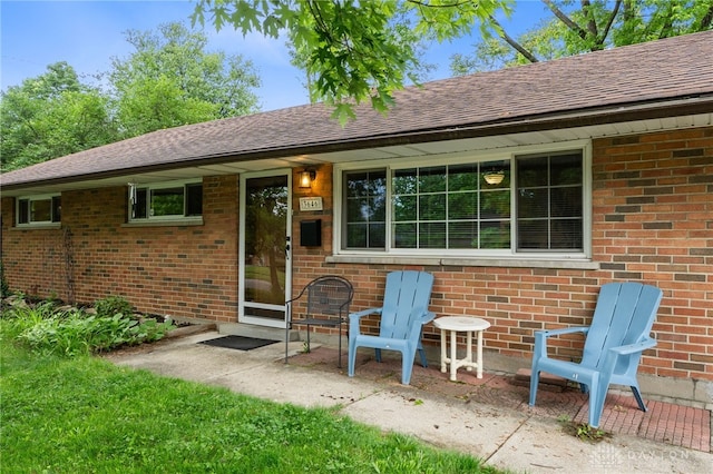 3646 Utica Dr, Dayton, OH 45439 - back of property with brick siding, roof with shingles, and a patio area