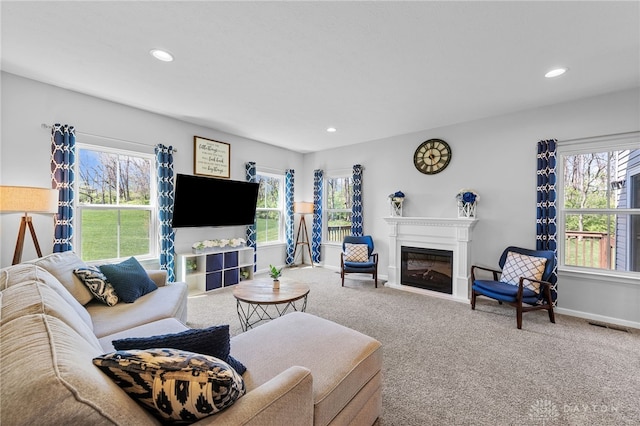 4069 Fawn Crossing Dr, Mason, OH 45040 - carpeted living area featuring plenty of natural light, recessed lighting, baseboards, and a glass covered fireplace