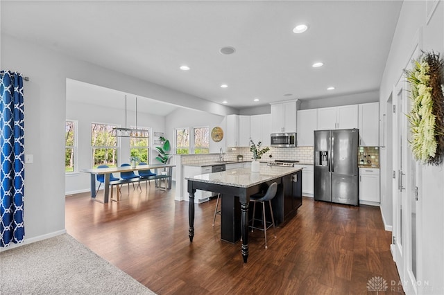 4069 Fawn Crossing Dr, Mason, OH 45040 - kitchen featuring appliances with stainless steel finishes, recessed lighting, tasteful backsplash, dark wood-style floors, and a peninsula