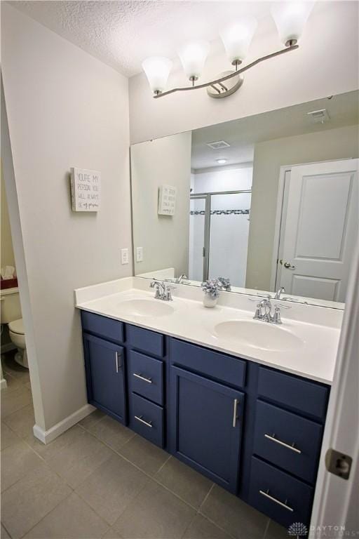 4069 Fawn Crossing Dr, Mason, OH 45040 - bathroom featuring double vanity, toilet, tile patterned flooring, a shower stall, and baseboards