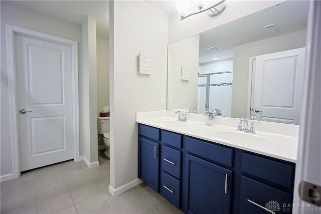 4069 Fawn Crossing Dr, Mason, OH 45040 - bathroom featuring double vanity, toilet, tile patterned floors, a stall shower, and baseboards